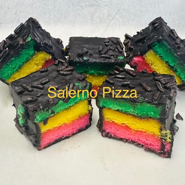 Five rainbow cookies with chocolate frosting and sprinkles, arranged on a white surface.